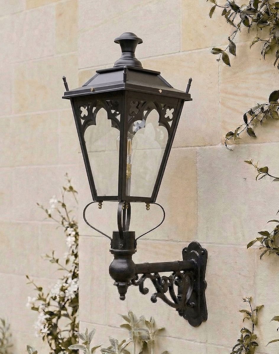Digital Illustration of the 102 x 54cm Black Gothic Wall Lantern on an Ornate Bracket Mounted on a Sunny Sandstone Wall