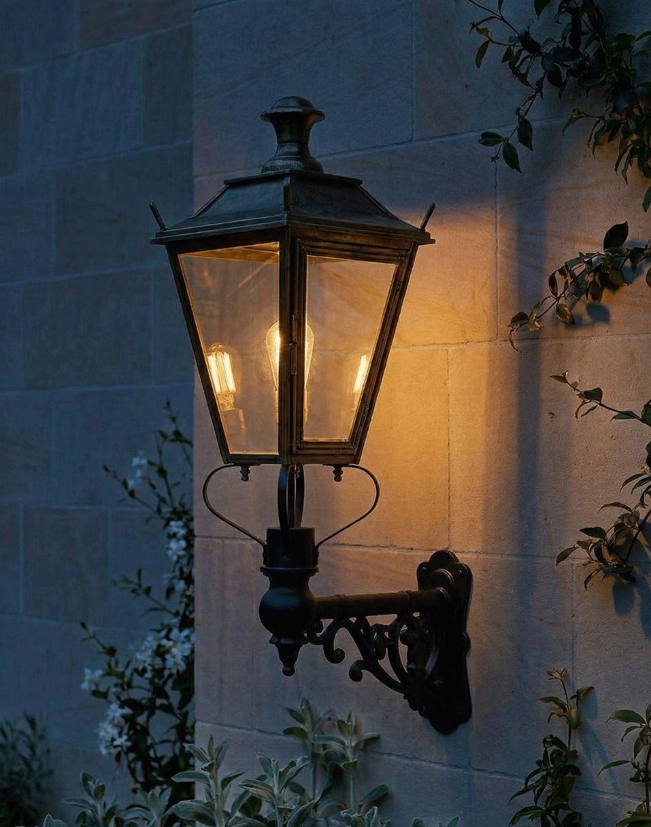 Digital Illustration of the 102 x 54cm Brass Dorchester Wall Lantern on an Ornate Bracket Lit up at Night