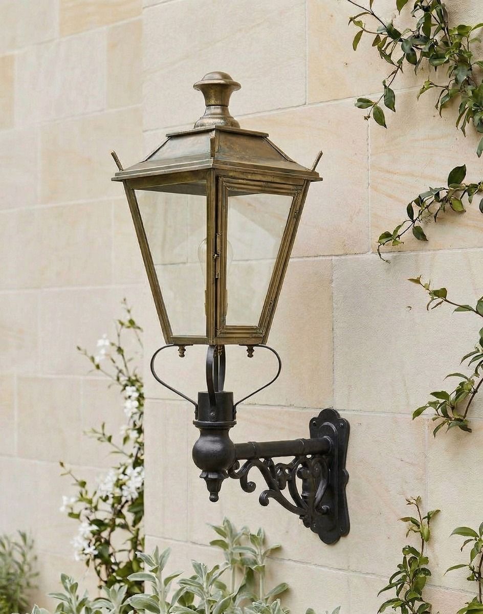 Digital Illustration of the 102 x 54cm Brass Dorchester Wall Lantern on an Ornate Bracket Mounted on a Traditional Sandstone Brick Wall