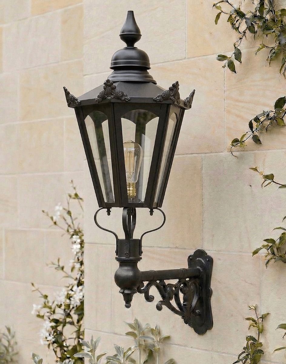 Digital Illustration of the 115 x 53cm Black Hexagonal Wall Lantern on Ornate Bracket Mounted on a Traditional Sandstone Brick Wall