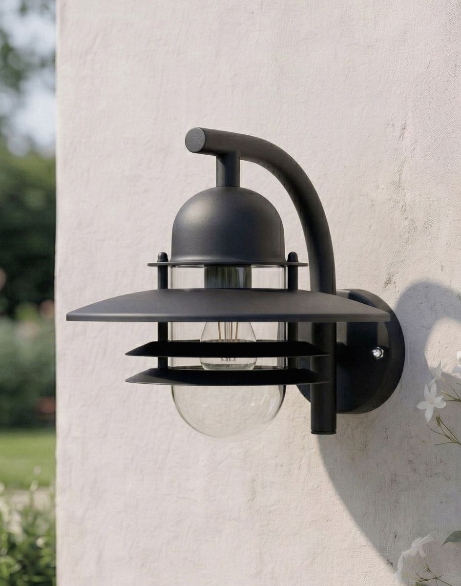 Digital Illustration of the "Chesil" Modern Overhanging Wall Light in Black Lit Mounted on a Outdoor Garden Wall