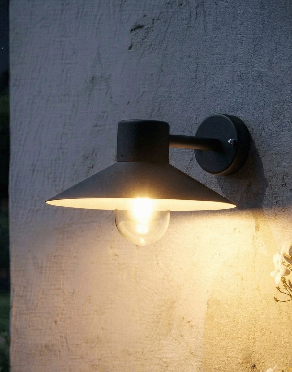 Digital illustration of the "Harrow" Contemporary Black Cone Shaded Wall Light Lit up at Night