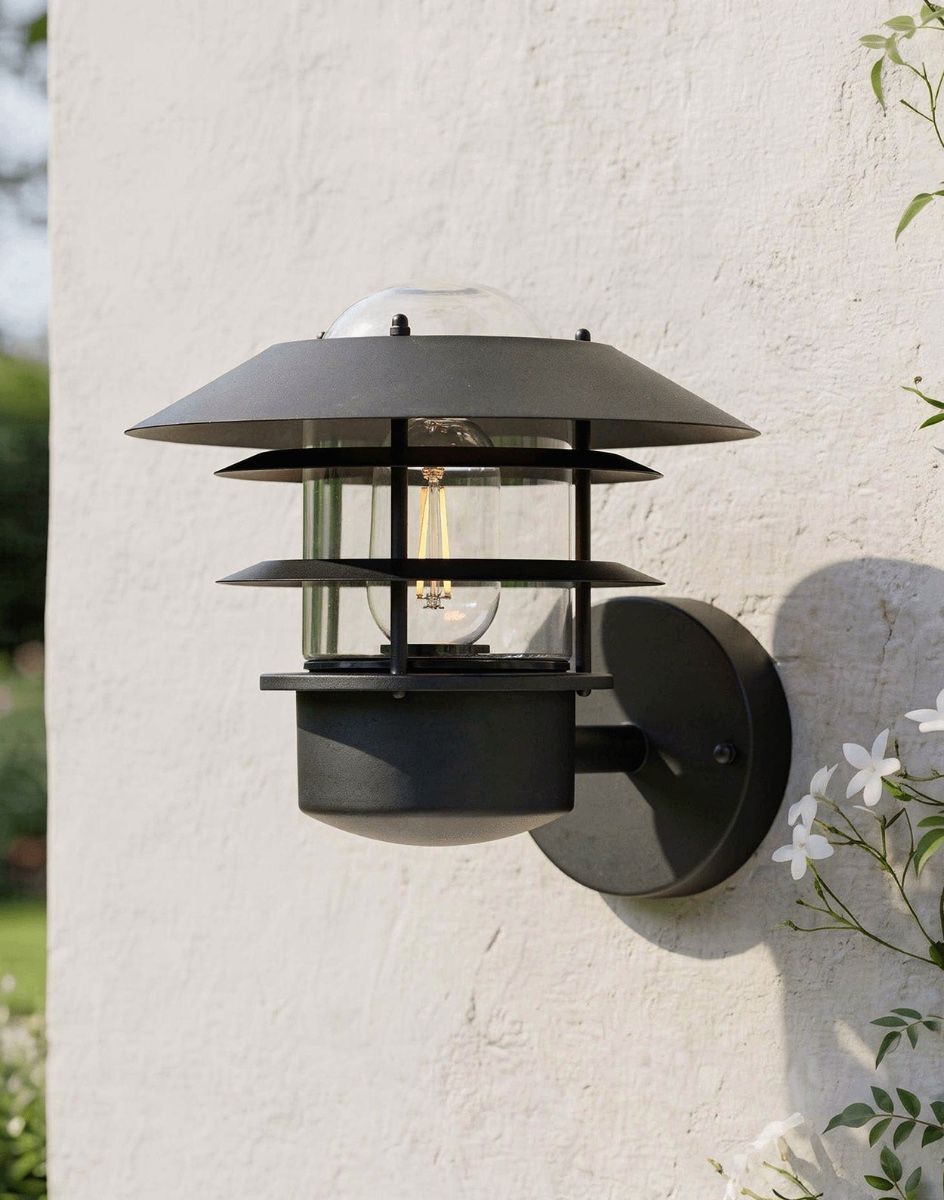 Digital Illustration of the "Skive" Contemporary Wall Light in Black Mounted on a Cream Coloured Sunny Garden Wall