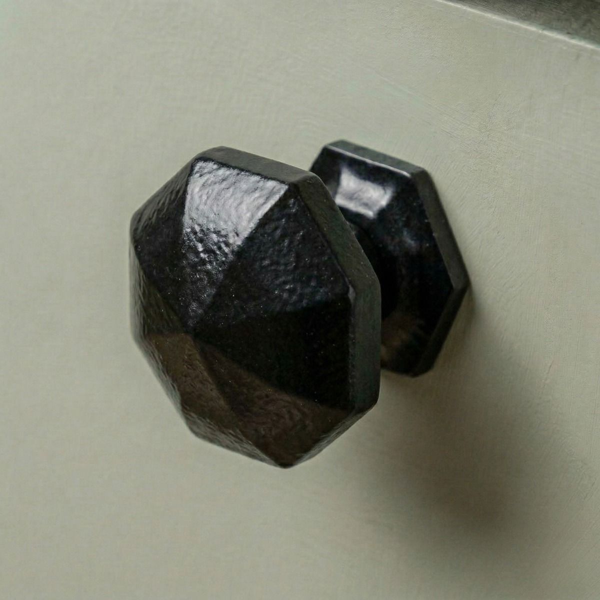 Digital Illustration of the 39mm Steel Powder Coated Octagonal Cabinet Knob Mounted on a Green Cupboard Door