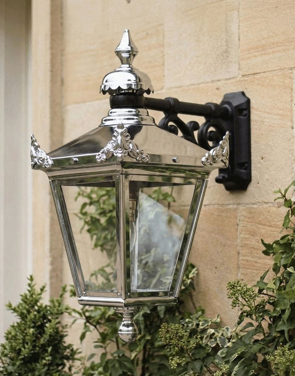 Digital Illustration of the 63 x 47.5cm Version of the Bright Chrome Suspended Wall Lantern Mounted on the Side of a Sandstone Building