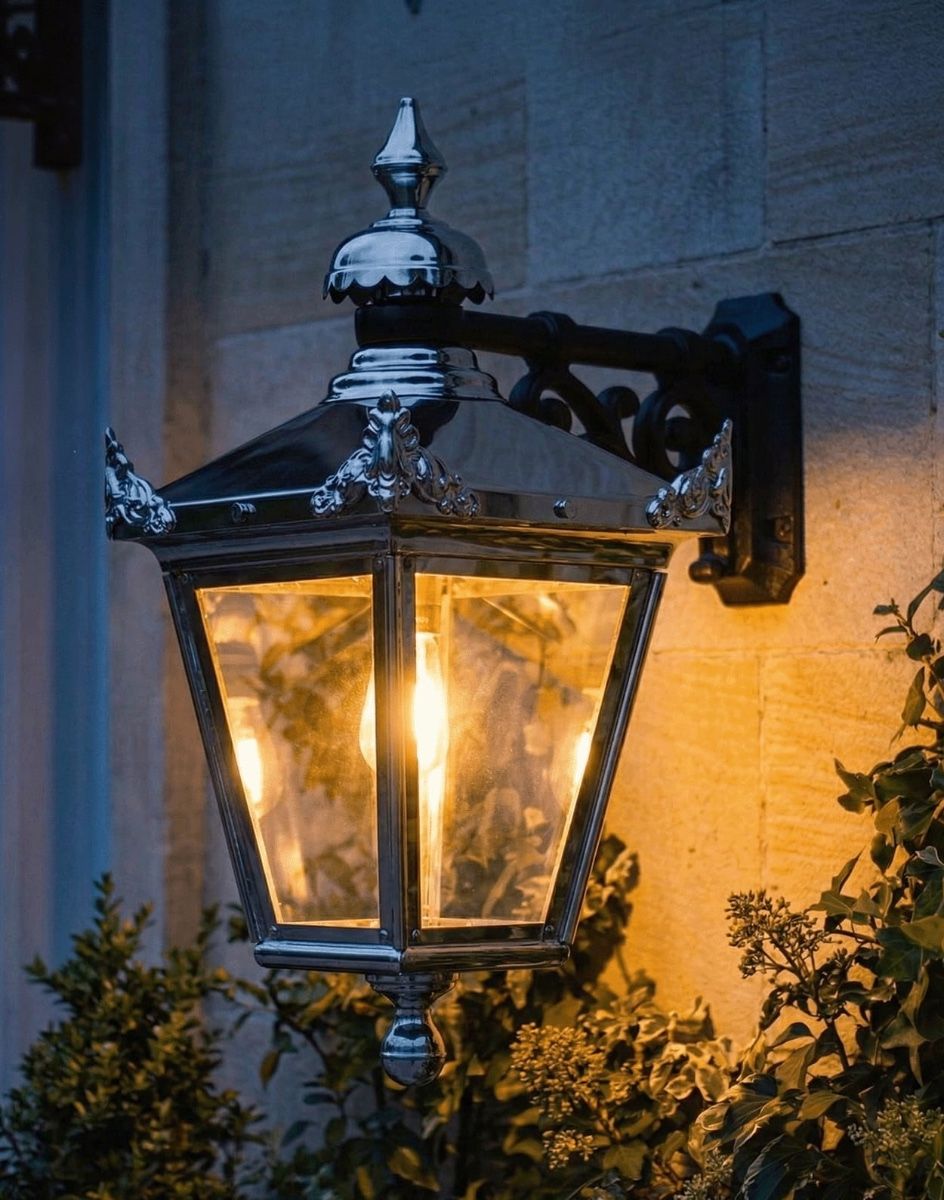 Digital Illustration of the 63 x 47.5cm Version of the Bright Chrome Suspended Wall Lantern Lit up at Night
