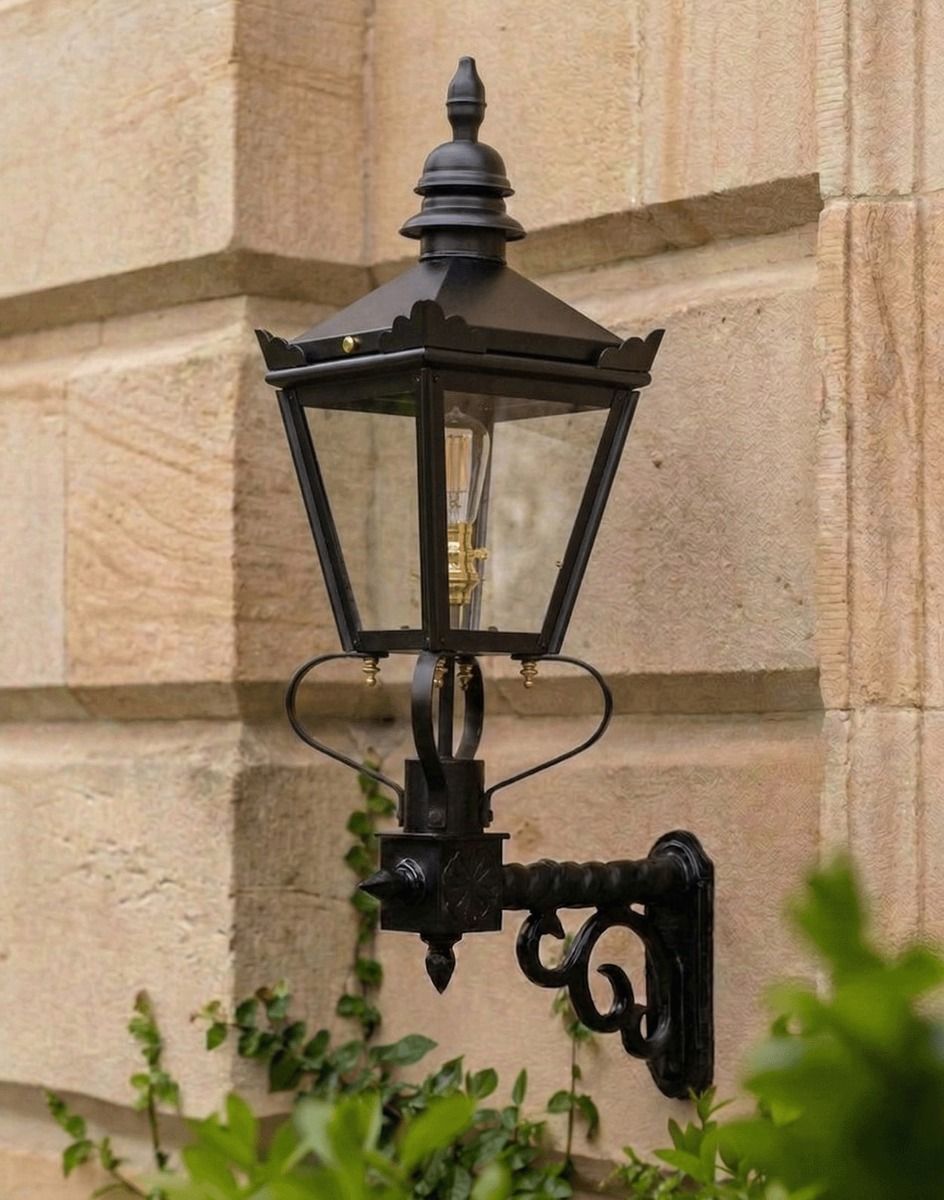 Digital Illustration of the 77 x 37cm Harrogate Wall Lantern On a Royale Bracket Mounted on a Traditional Sandstone Brick Building Wall