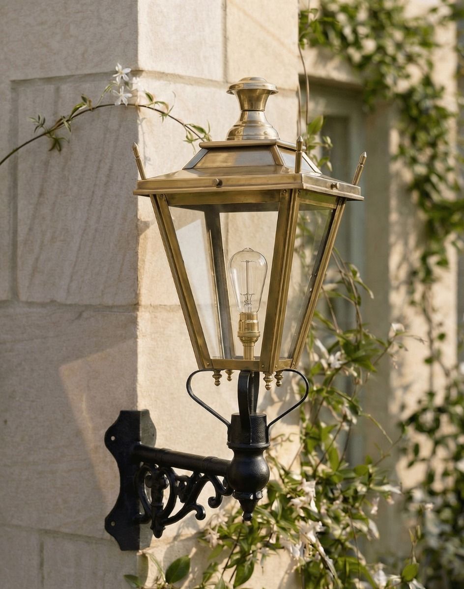 Digital Illustration of the 84 x 37cm Brass Dorchester Wall Lantern on a Corner Bracket Mounted on a Sandstone Brick Garden Wall