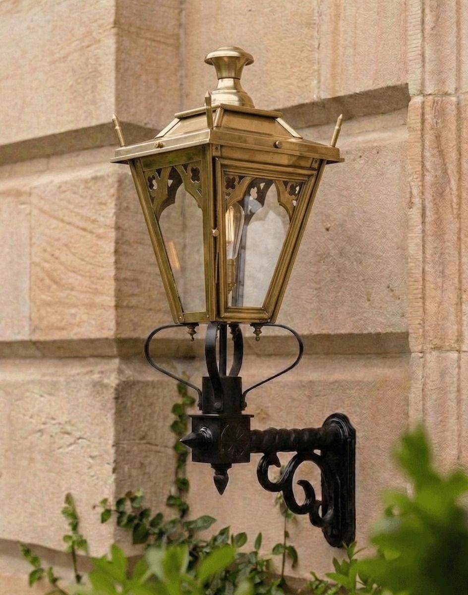 Digital Illustration of the 84 x 37cm Brass Gothic Wall Lantern on a Royale Bracket Mounted on a wall of a Sandstone Brick Building