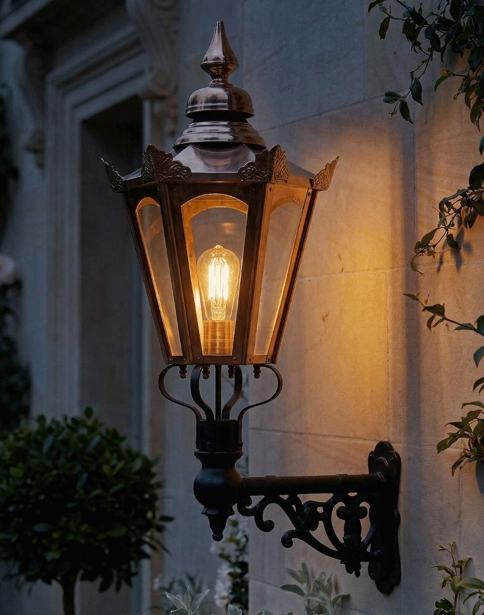 Digital Illustration of the 88 x 33cm Copper Hexagonal Wall Lantern on an Ornate Bracket Lit up at Night