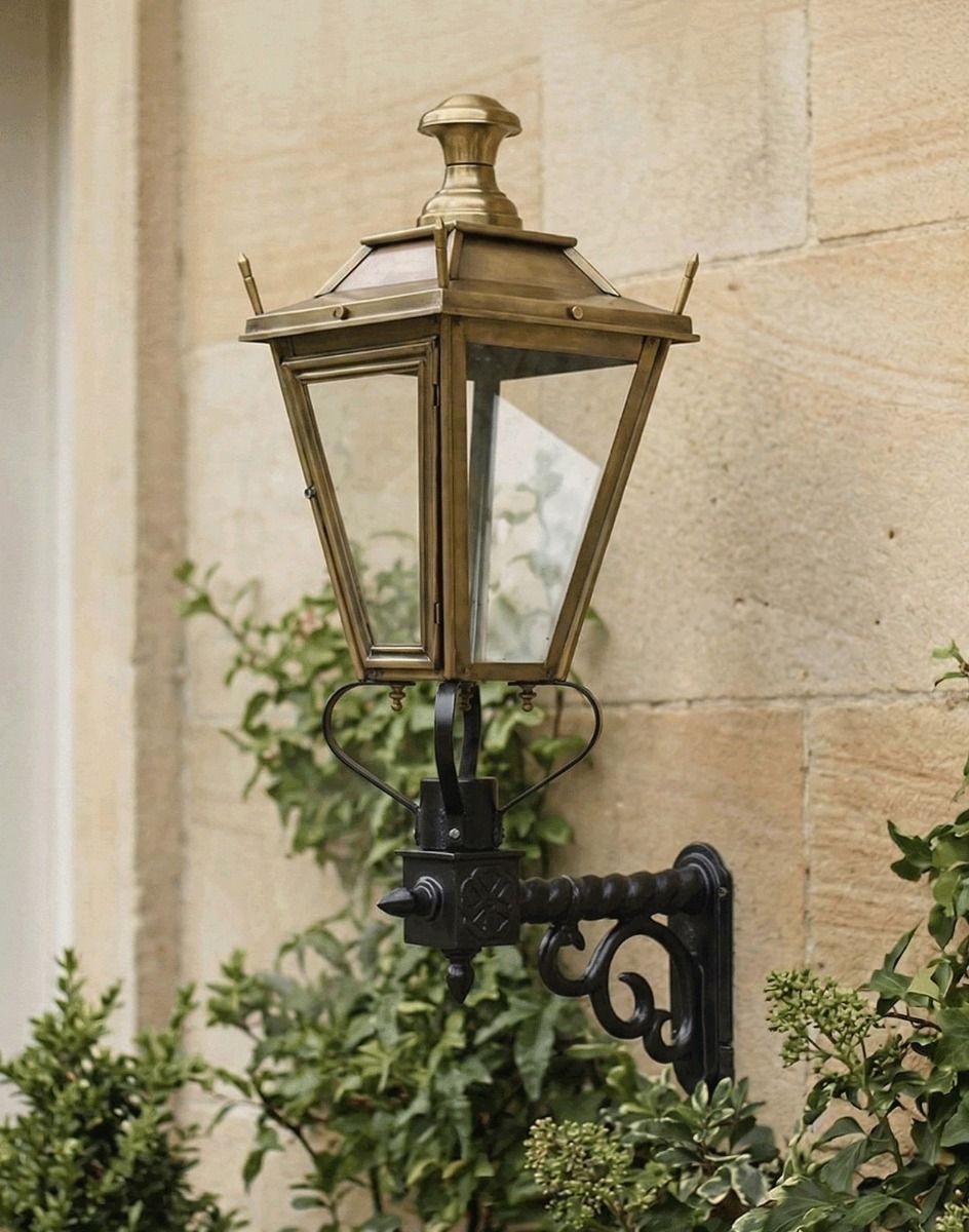 Digital Illustration of the 95 x 48cm Brass Dorchester Wall Lantern on a Royale Bracket Mounted on a Standstone Brick Walled Building 