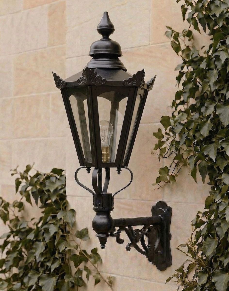 Digital Illustration of the 98 x 46cm Black Hexagonal Wall Lantern on an Ornate Bracket Mounted on a Limestone Brick Garden Wall 