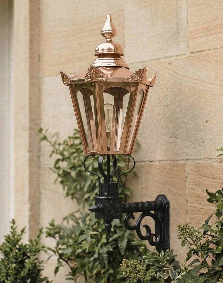 Digital Illustration of the 98 x 46cm Copper Hexagonal Wall Lantern on a Royale Bracket Mounted on a Sandstone Brick Building