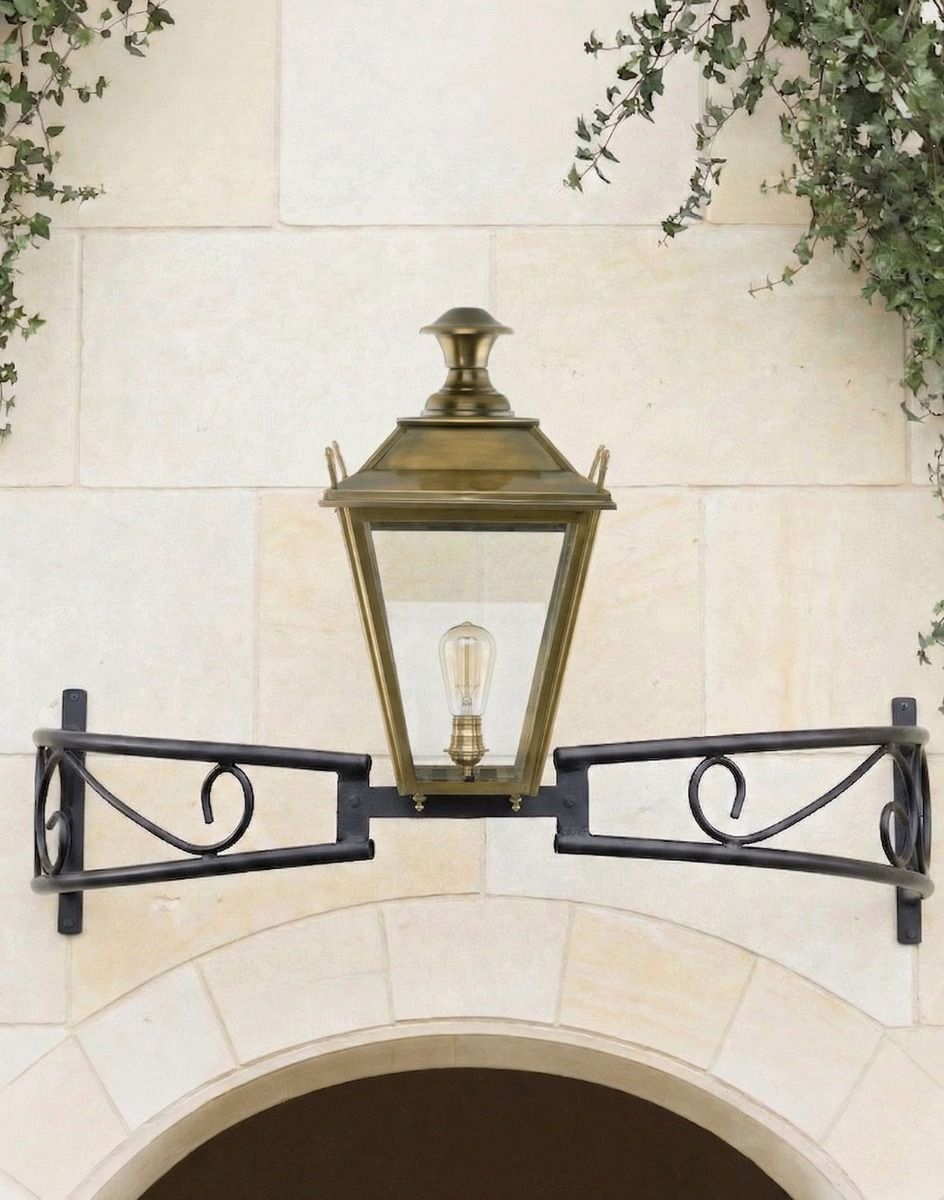 Digital Illustration of the Antique Brass Dorchester Bow Bracket Light Mounted Above a Building Archway
