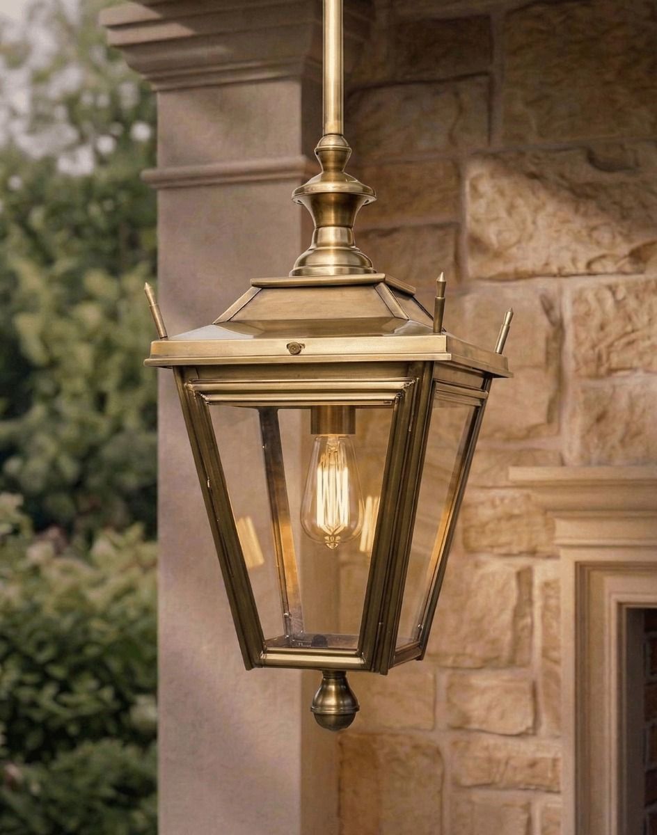 Digital Illustration of the Antique Brass Dorchester Hanging Lantern Suspended Above a Stone Porch