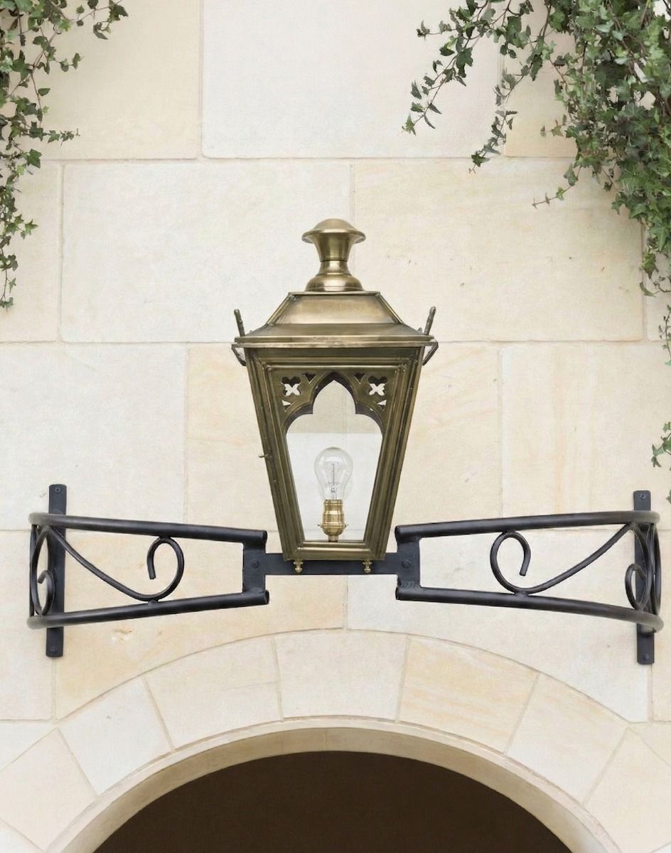 Digital Illustration of the Antique Brass Gothic Bow Bracket Light Mounted Above a Stone Archway