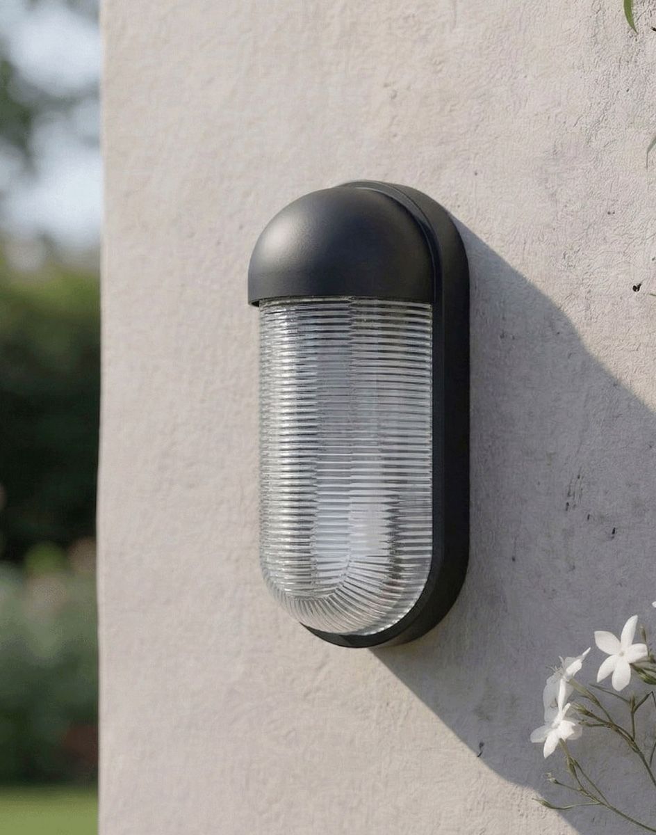 Digital Illustration of the Black Contemporary "Hurley" Cylinder Wall Light Mounted on a White Garden Wall in the Sun