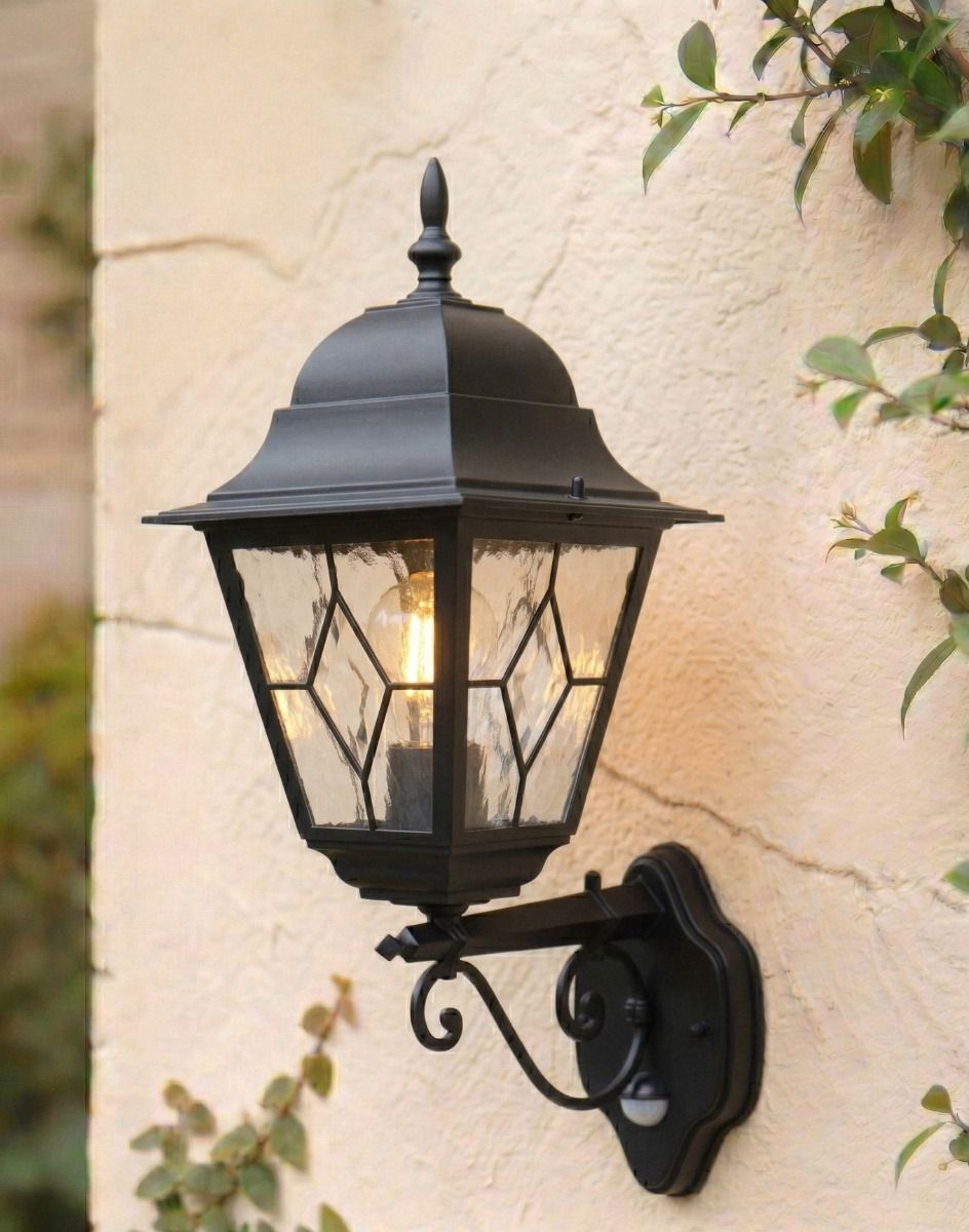 Digital Illustration of the Black Traditional Wall Lantern With Built in PIR Motion Sensor Mounted on a Rustic Cottage Wall