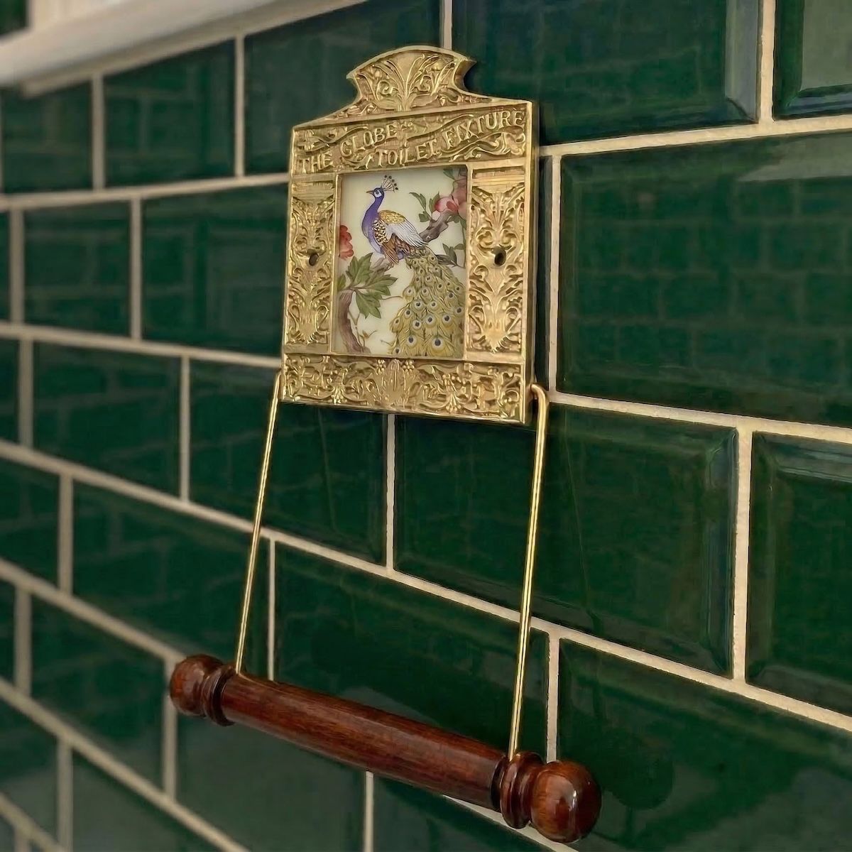 Digital Illustration of the Brass Version of the Globe Toilet Fixture Empty Mounted on Green Bathroom Tiles