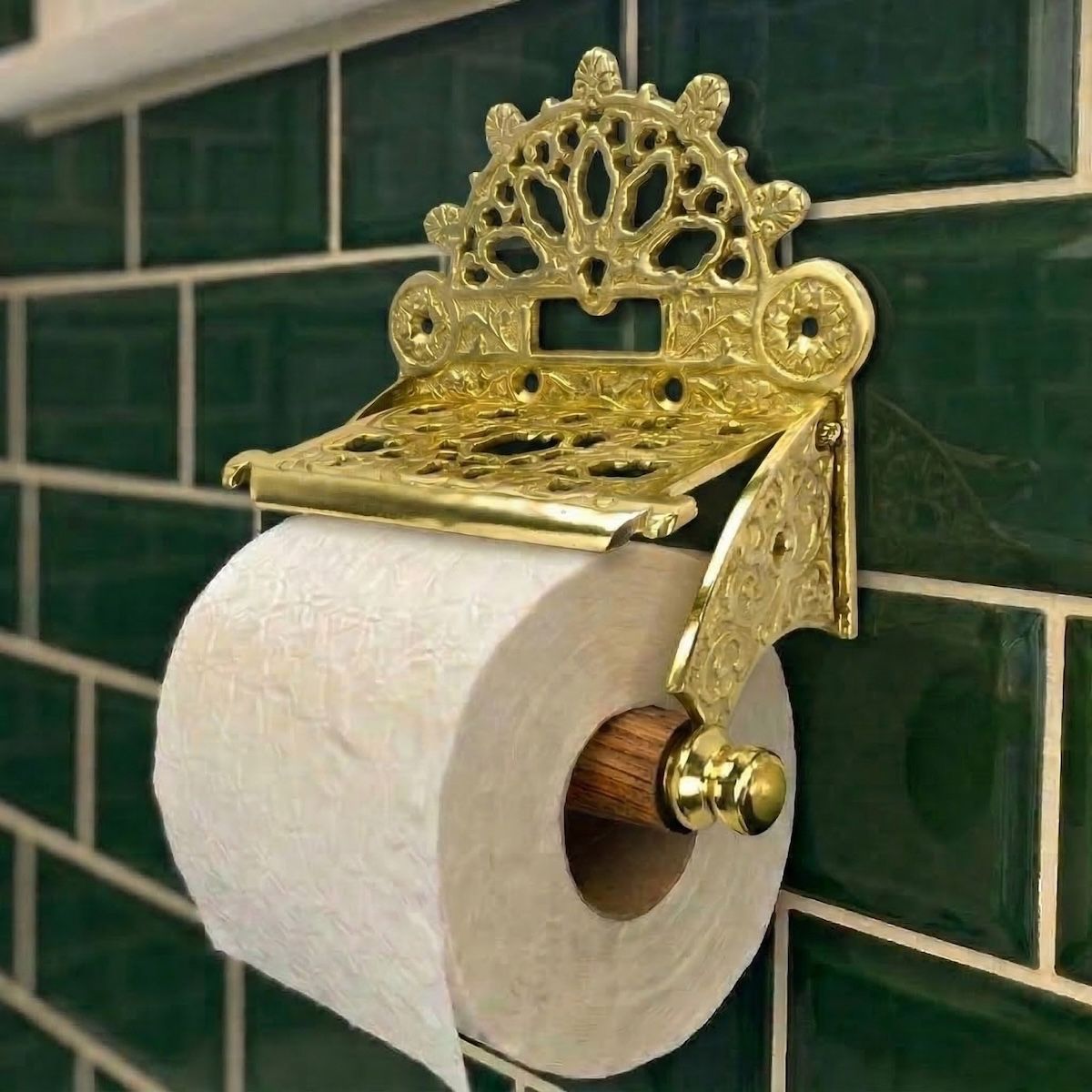 Digital Illustration of the Brass Version of the Sunrise Toilet Roll Holder Holding Toilet Role Mounted on Green Bathroom Tiles