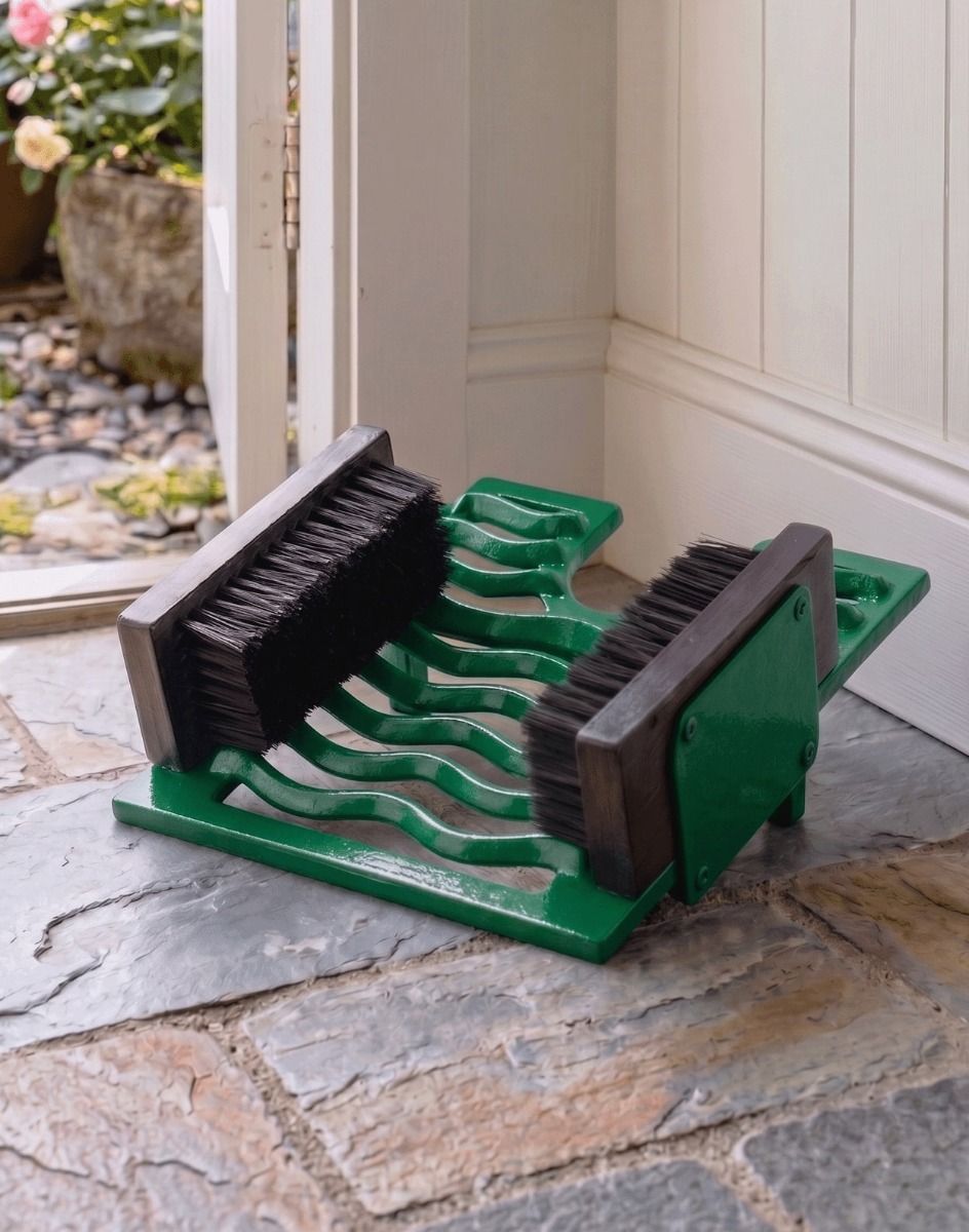 Digital Illustration of the Green Three in One Black Boot Jack Boot Brush and Scraper Placed on a Stone Floor Cottage Hallway