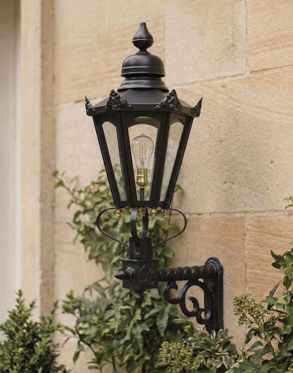 Digital illustration of the Medium Black Concordia Hexagonal Lantern on a Royale Bracket Mounted on a Traditional House Porch Wall