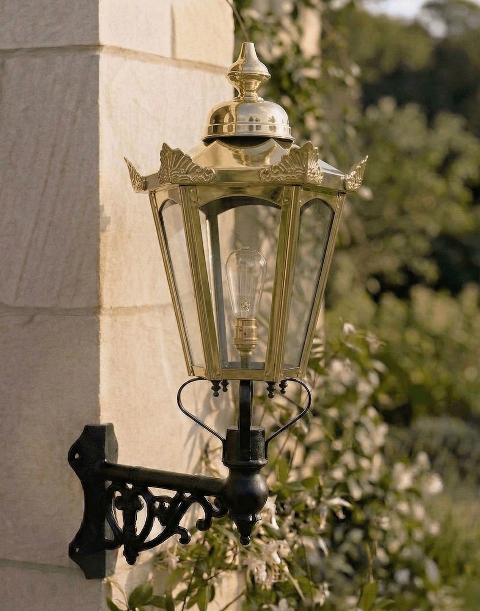 Digital Illustration of the Medium Brass Concordia Hexagonal Lantern With a Corner Bracket Mounted on Sunny Sandstone Brick Building