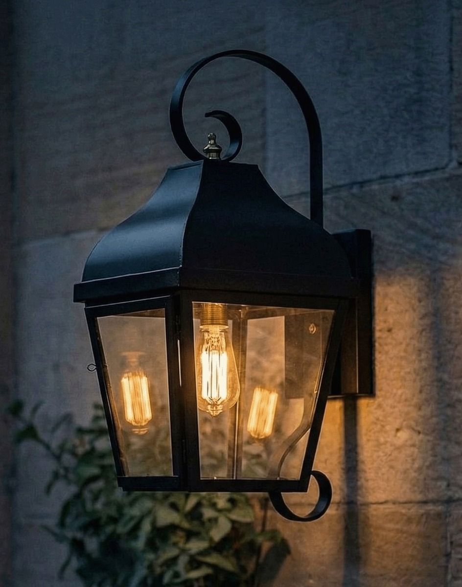 Digital Illustration of the Midnight Black Flush Wall Lantern With Scrolled Bracket Lit up at Night