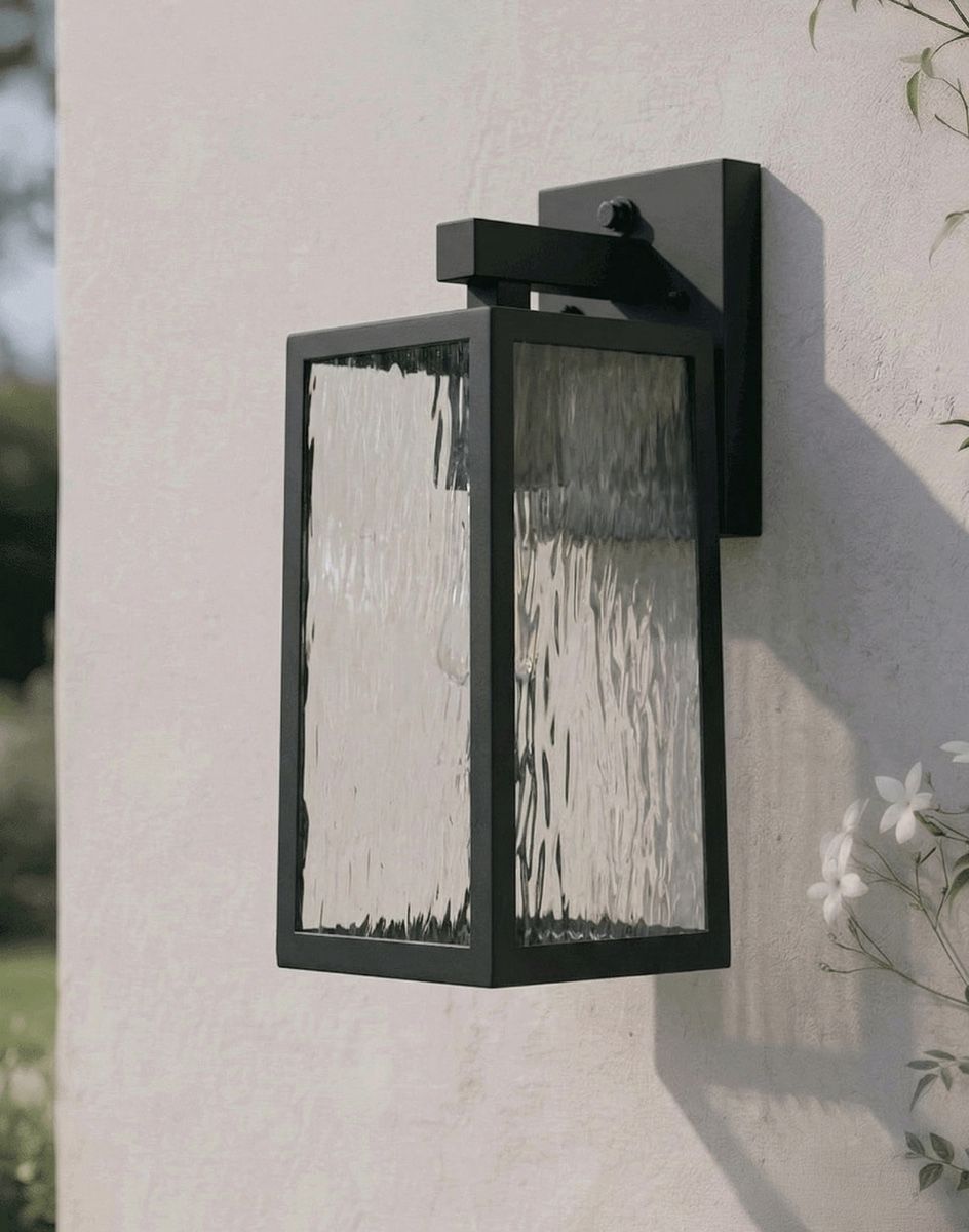 Digital Illustration of the Oakley Top Fix Wall Light in Black Mounted on a Cream Coloured Garden Wall in the Sun