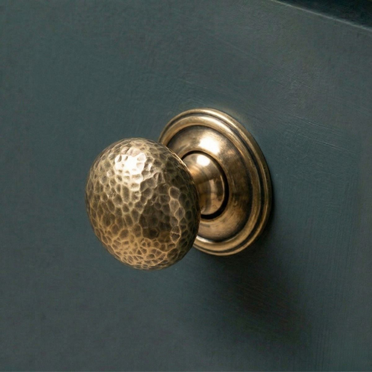 Digital Illustration of the Polished Copper Hammered Mushroom Cabinet Knob Mounted on a Blue Cupboard Door