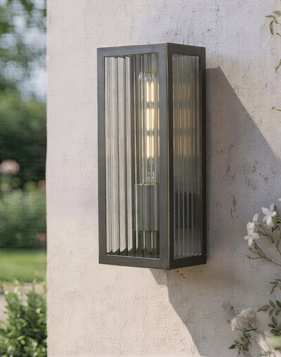 Digital Illustration of the Rubbed Bronze Reeded Glass Wall Light Fixed on a Sunny White Garden Wall