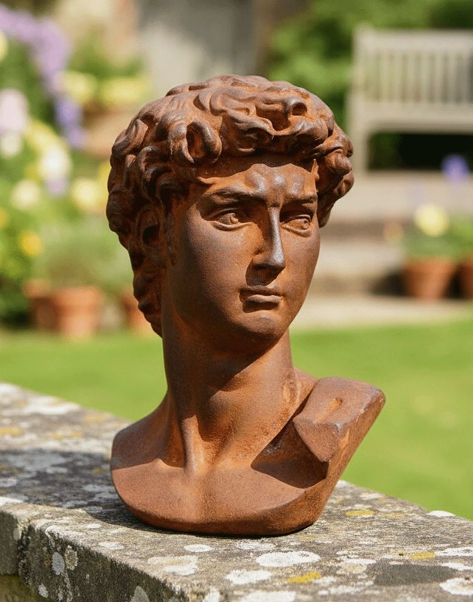 Digital Illustration of the Rustic Cast Iron "Bust of David" Sculpture on a Garden Wall with a Sunny Garden Scene Behind