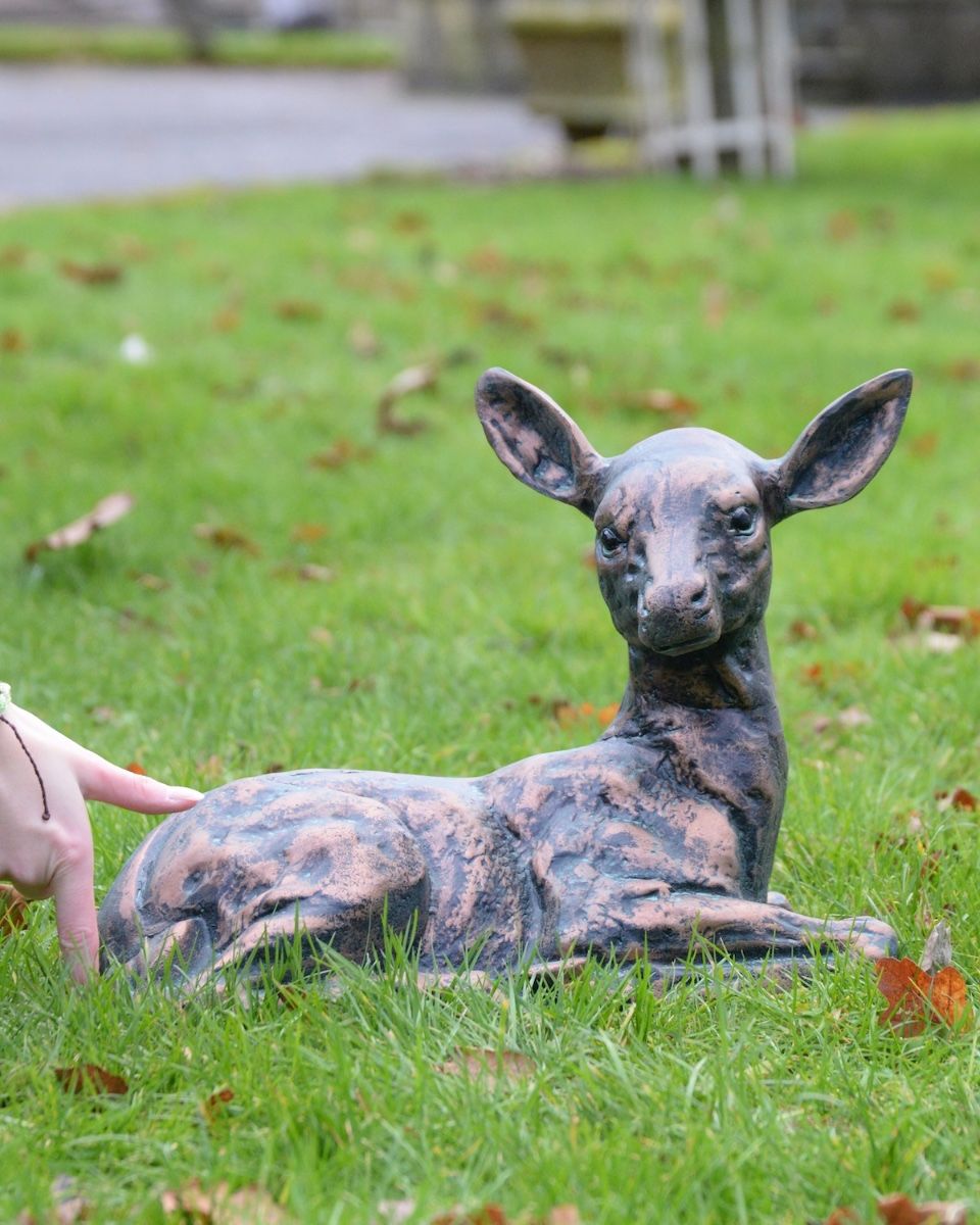 Digital illustration of Verdigris "Blossom" the Doe Sculpture with hand in shot for scale