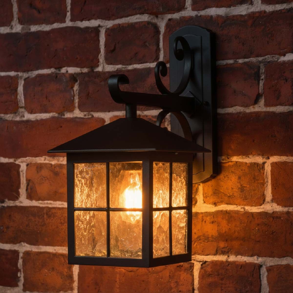 Digital representation of "Halifax" Traditional English Top Fix Wall Lantern with Scrolled Bracket lit up at night
