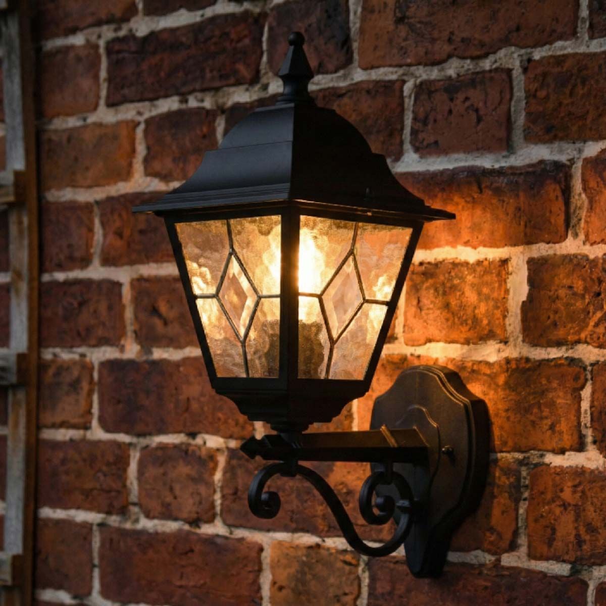Digital representation of "Sheringham" Traditional Black Bottom Fix Wall Lantern lit up at night