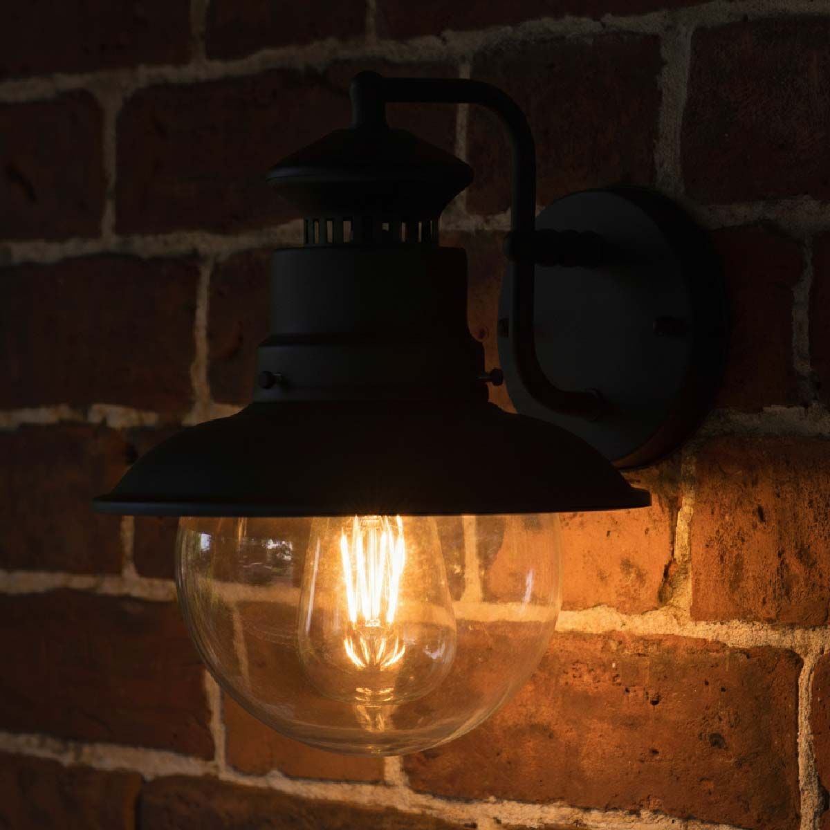 Digital representation of "Westcliff" Traditional Black Wall Lantern lit up at night