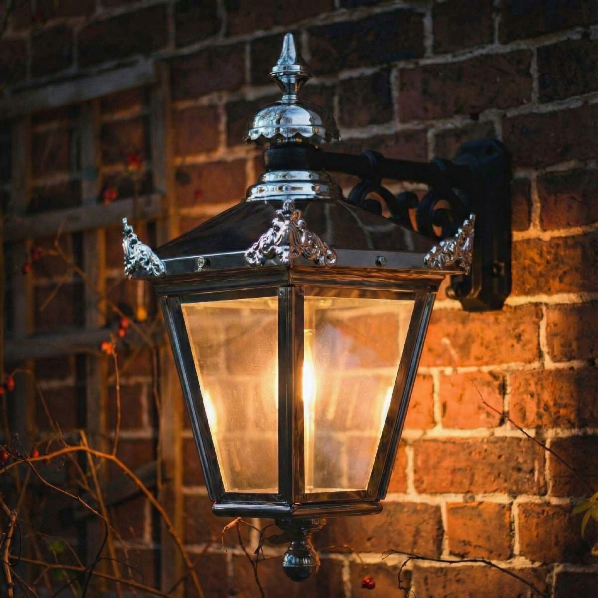 Digital illustration of Bright Chrome Suspended Wall Lantern 63 x 47.5cm lit up at night