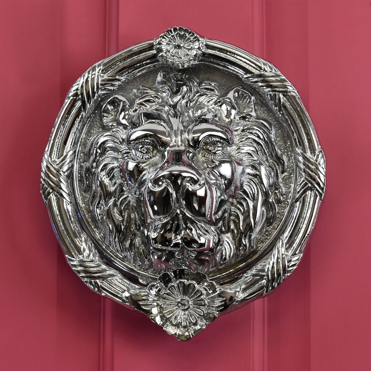 large round Bright Chrome Sandringham door knocker on red door large round Bright Chrome Sandringham door knocker on red door