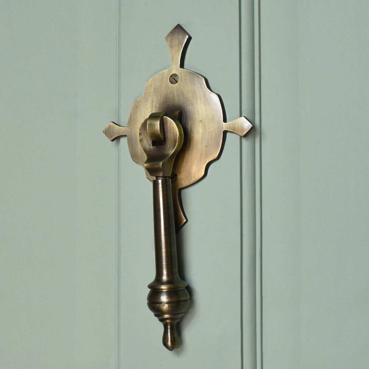 Antique Brass Door knocker on pastel green door door