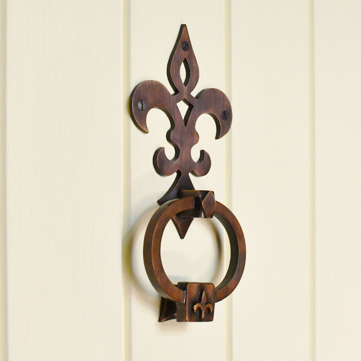 Antique copper Period style door knocker on cream door