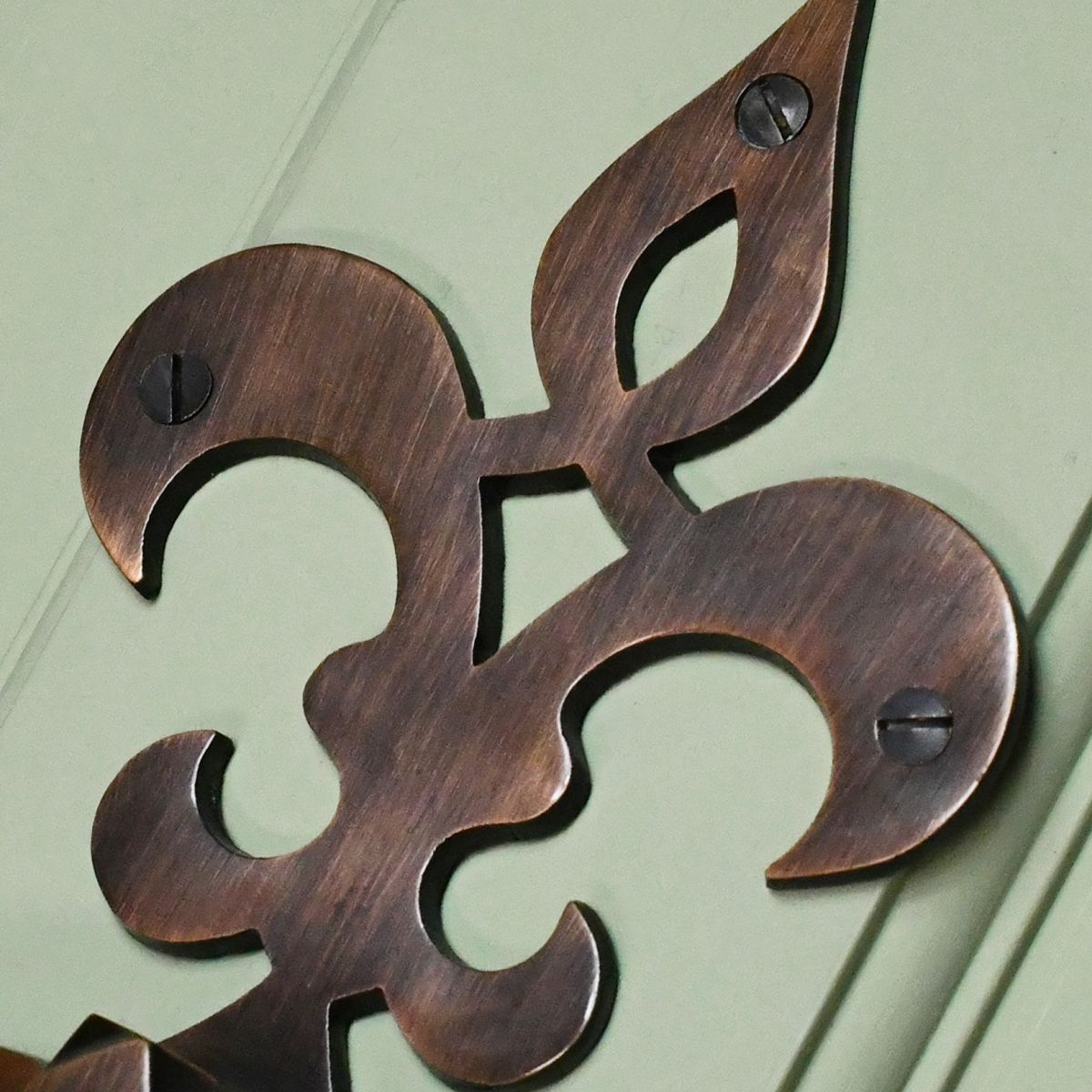 Close up of French Fleur de lys symbol door knocker