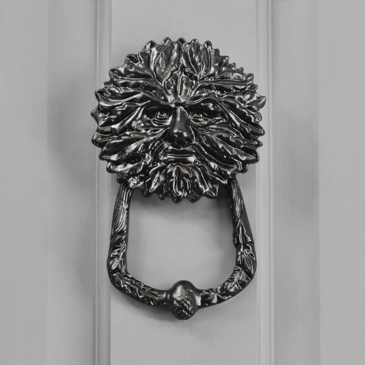 Green man door knocker on front door