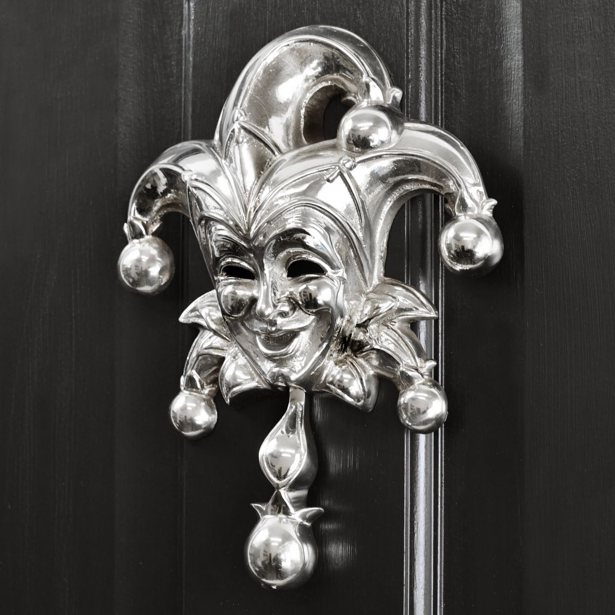 Bright Chrome Jester door knocker on black door
