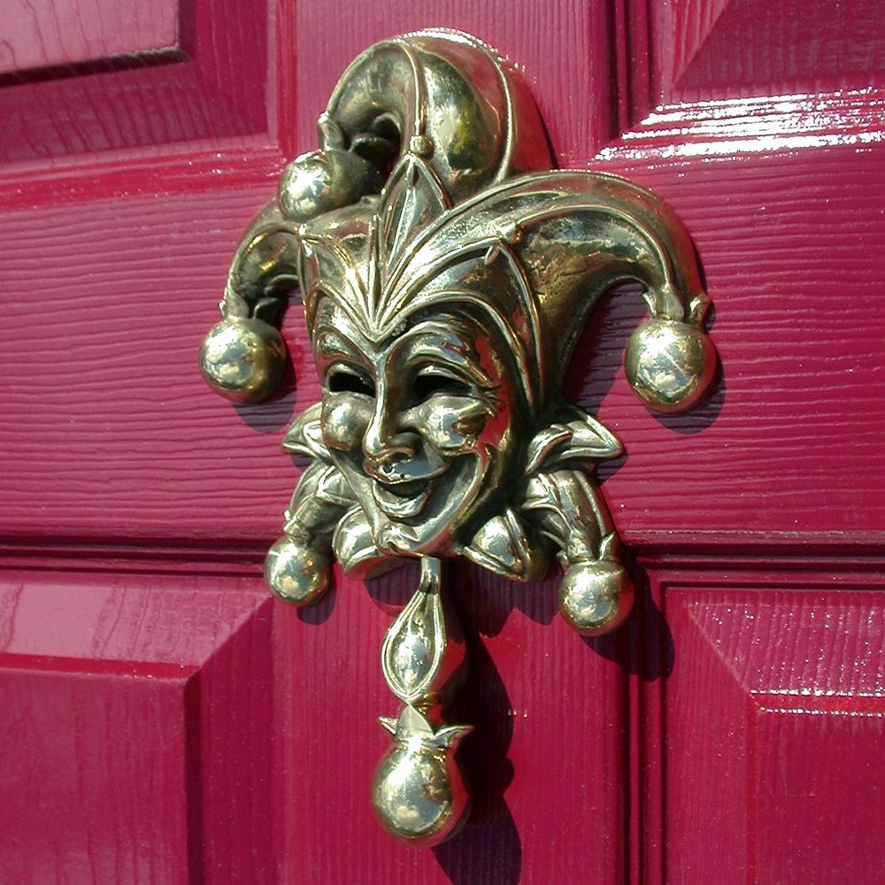 Polished brass jester Door knocker on red door