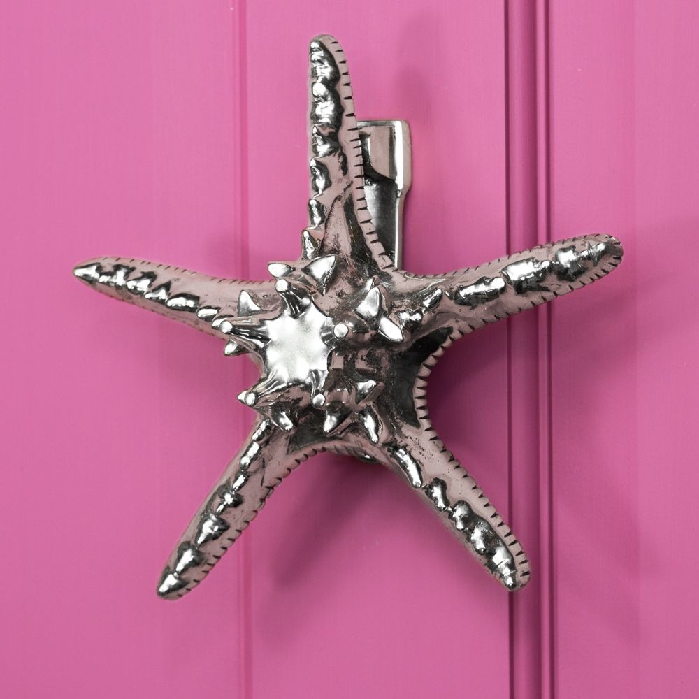 Bright Chrome Star Fish door knocker on pink door