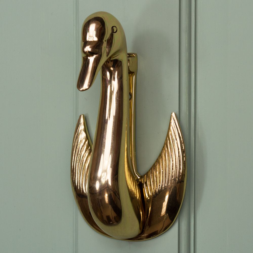 Brass Swan design door knocker on Green door
