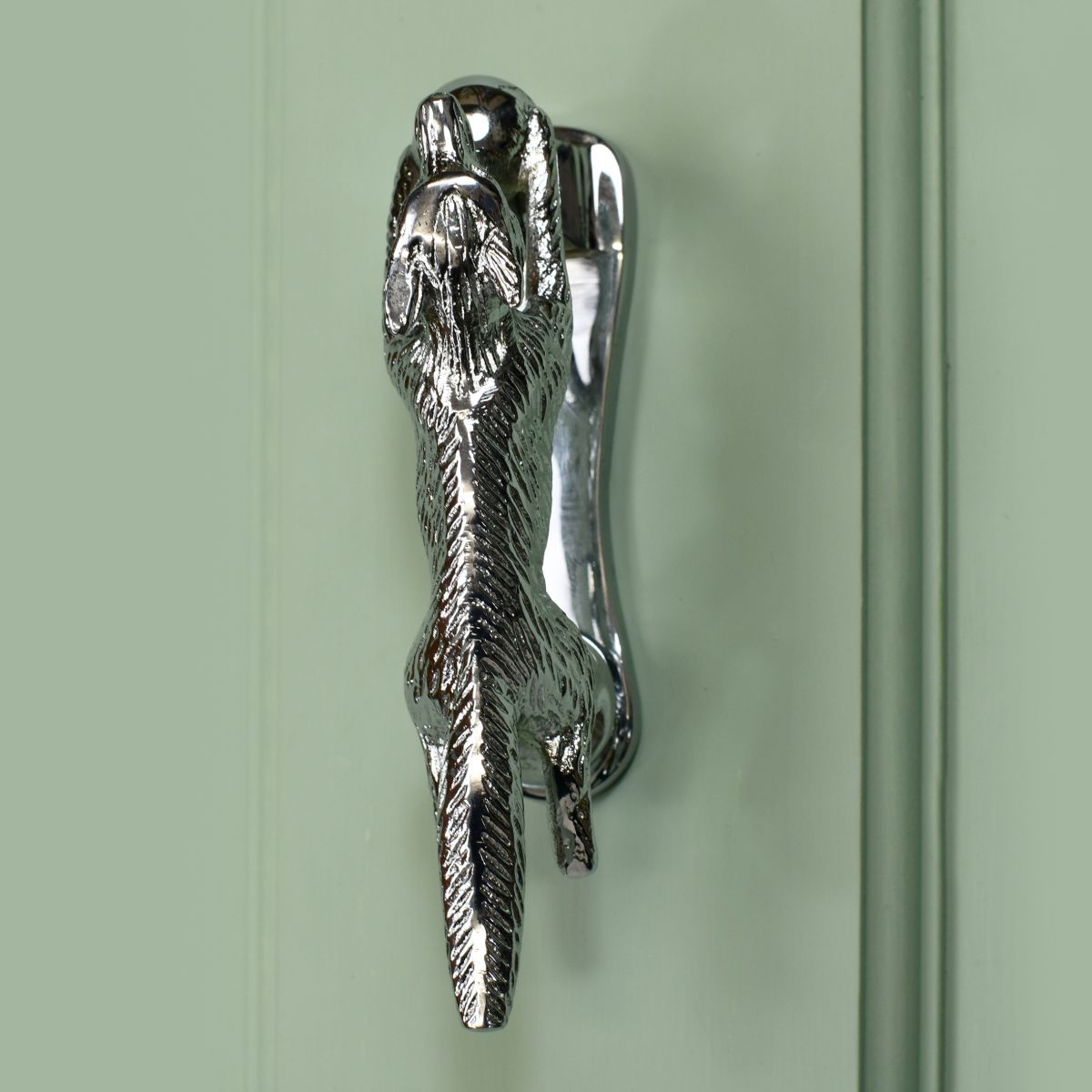 Bright Chrome Running fox door knocker on green door Bright Chrome Running fox door knocker on green door