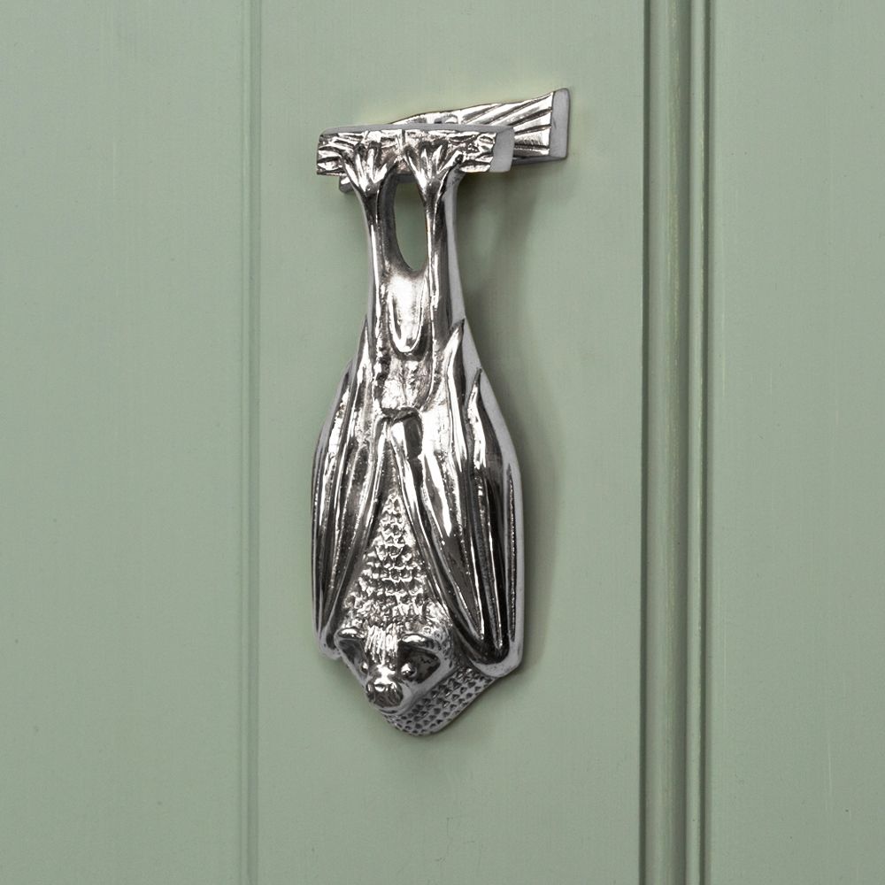 Bright Chrome Bat Door Knocker on pale Green Door