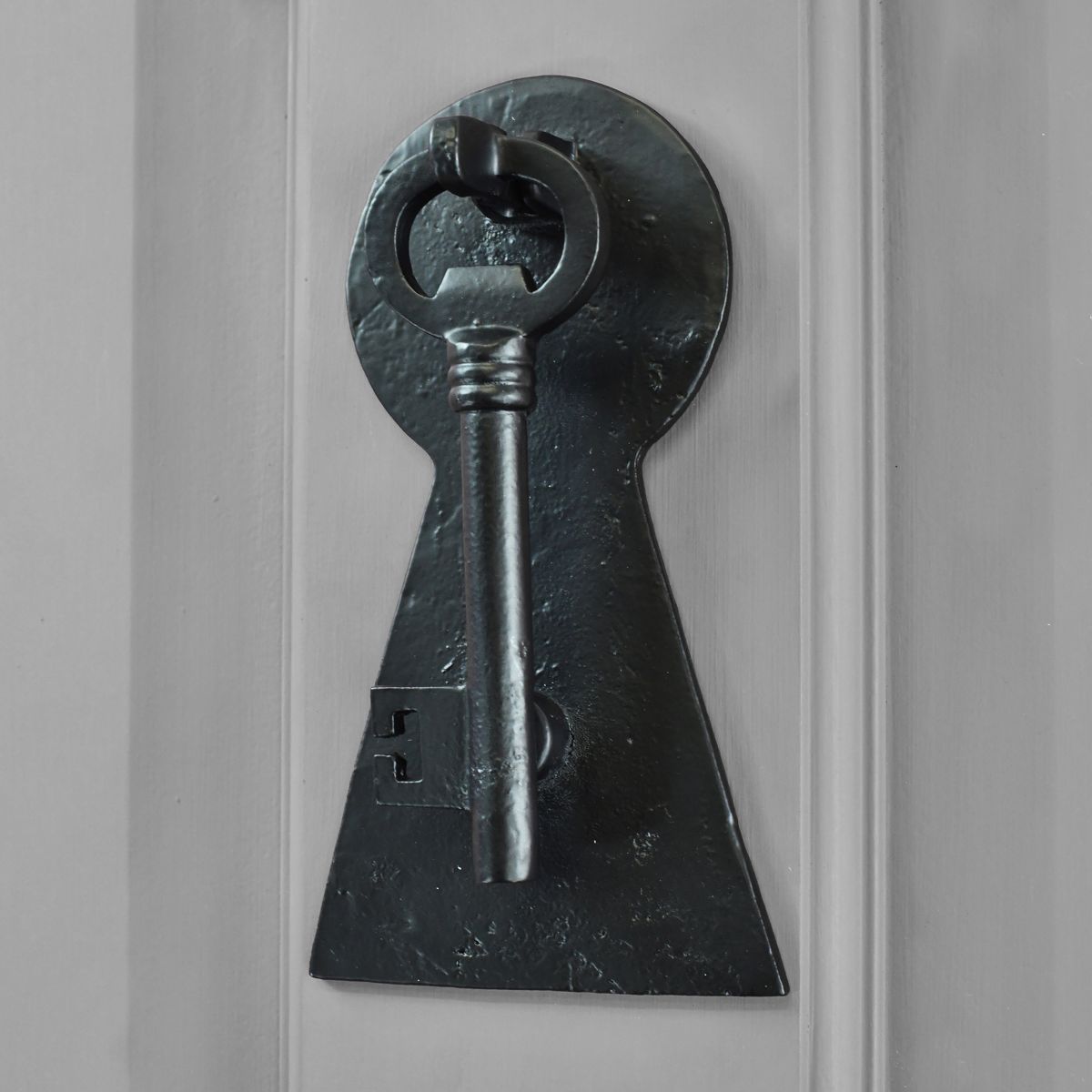 Black Iron Key door knocker on grey door
