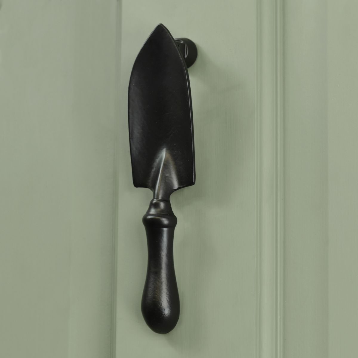 Black Trowel Door Knocker on Green door